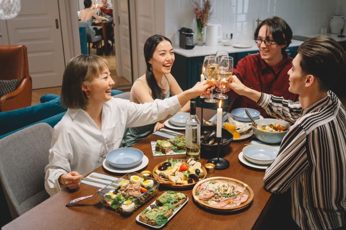 Friends seated together at a dinner party table