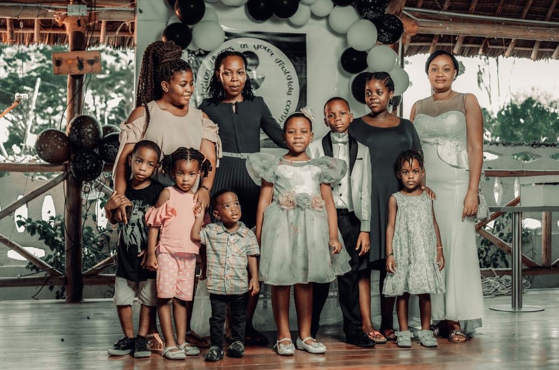 A multi-generational family gathered together, smiling